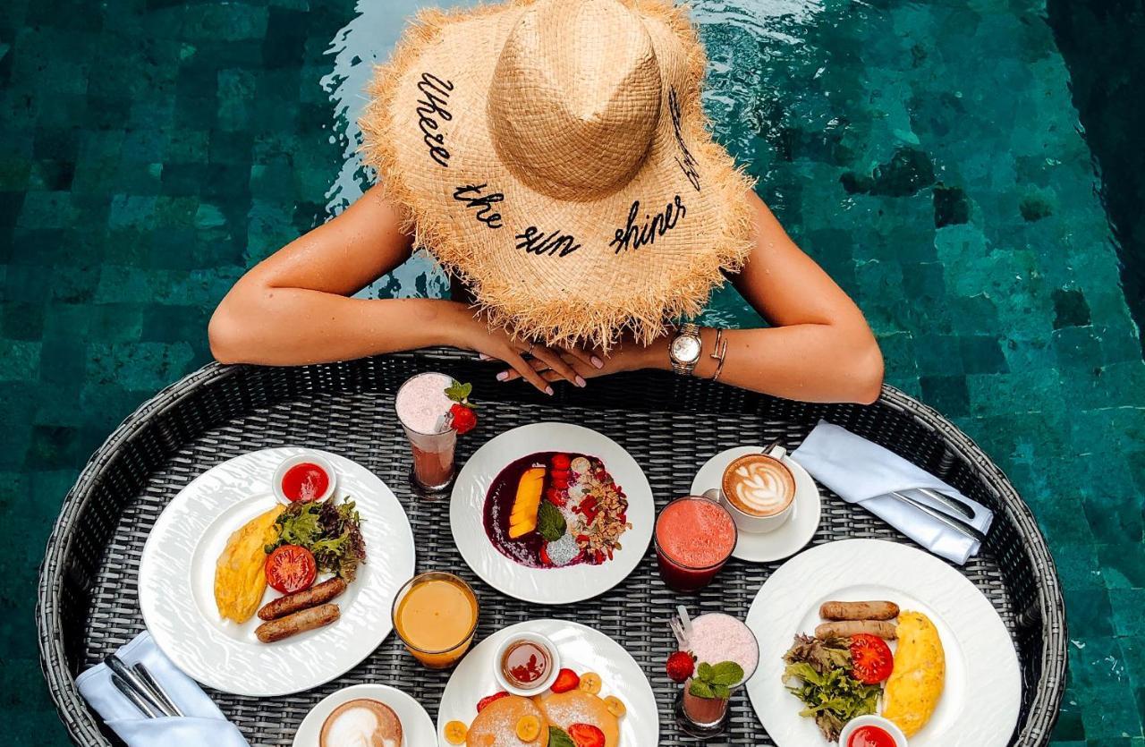 Goya Boutique Resort Ubud Exterior foto A woman wearing a hat